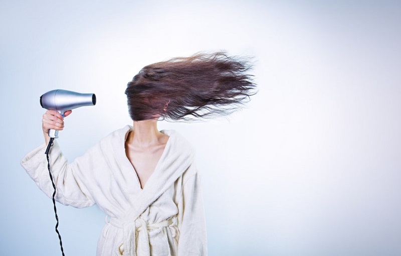 Woman using hair dryer