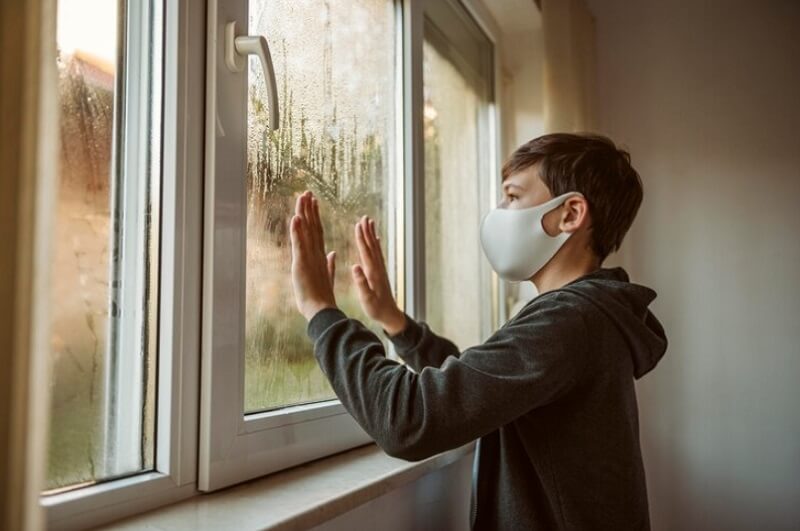 man wearing mask and hold the window