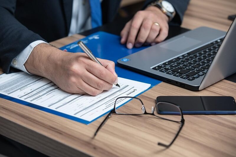 man writing in file