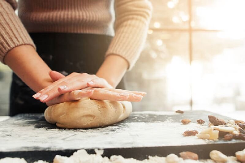 Woman making dough for cookies