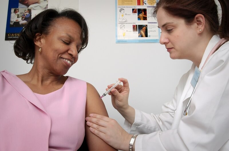female doctor injecting