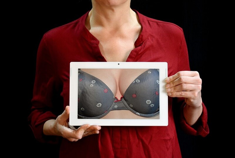 holding ipad with breast image