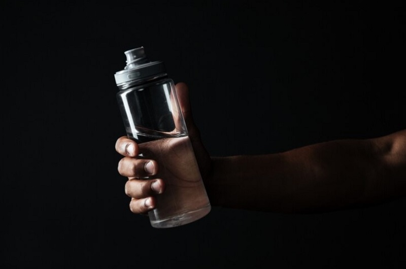 man hand holding water bottle