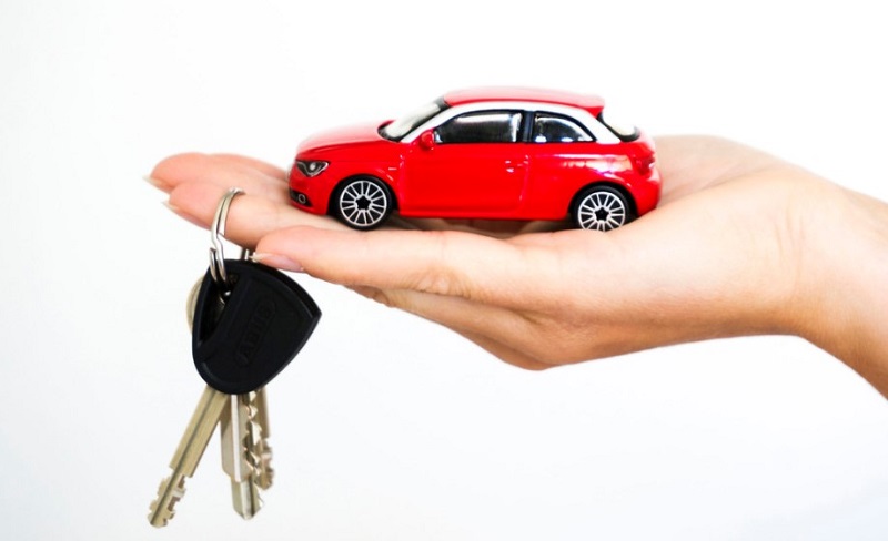 toy-red-car-and-keys-on-hand