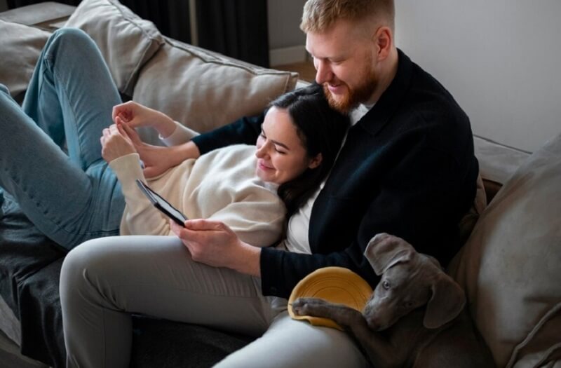 couple watching movie on the phone at home