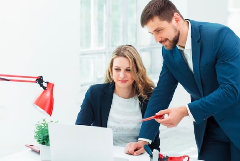 man and girl working together in the office