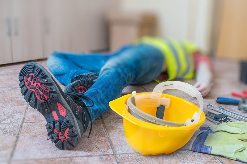 person laying on the floor and a safety cap on the floor